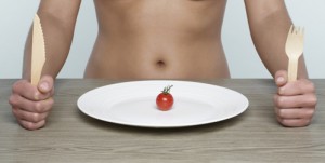 Young Woman Eating Cherry Tomato
