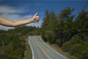 Woman hitchhiking --- Image by © Plush Studios/Blend Images/Corbis